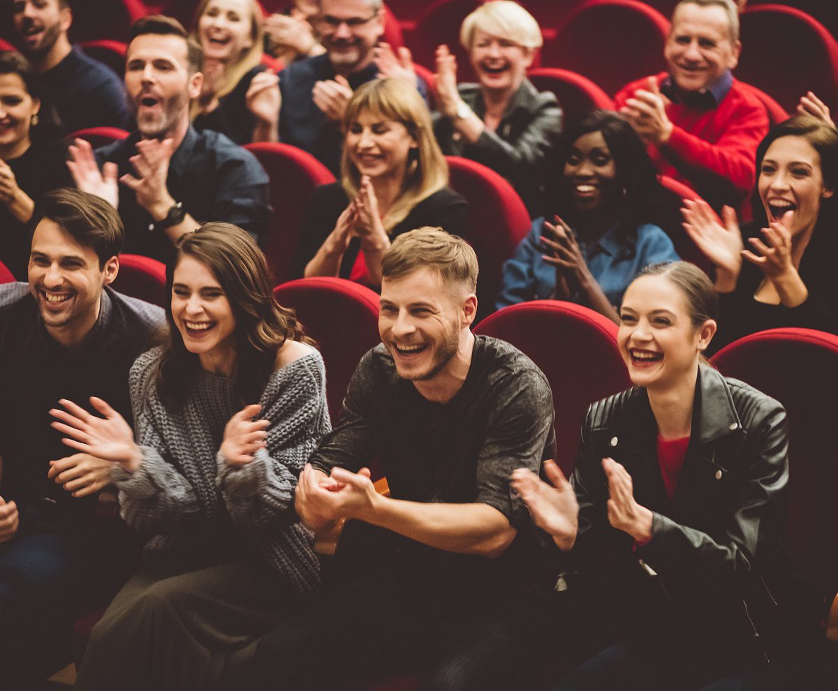 A group of people sitting in front of each other.